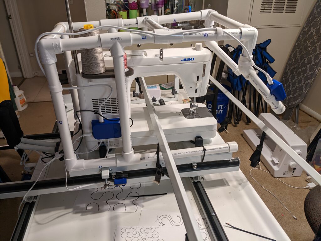 My Juki TL2000Qi set up on the Cutie frame with PVC top handles.