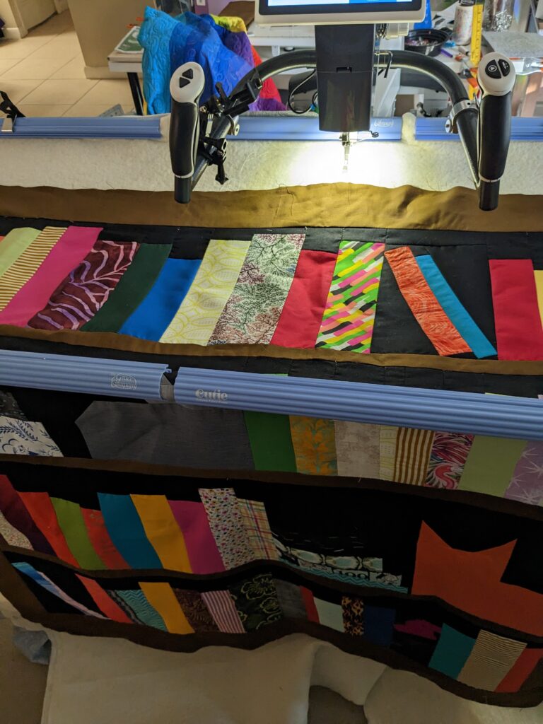 The bookcase quilt hooped on the Cutie frame ready to be quilted.