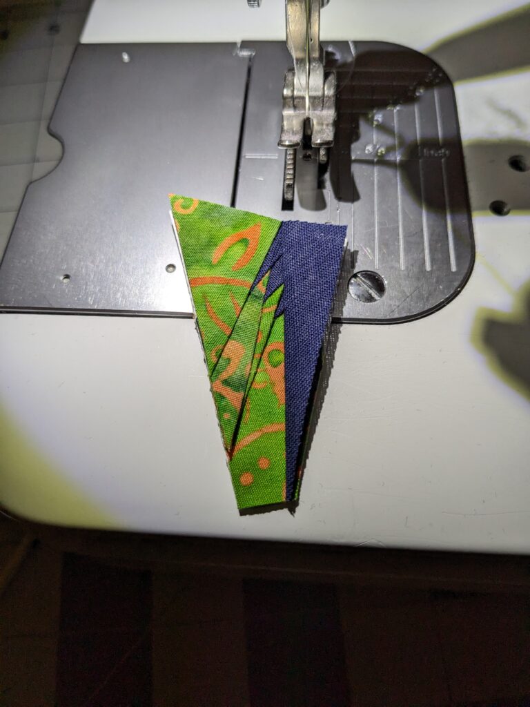 A very small piece of row 5 showing the green and blue fabrics.