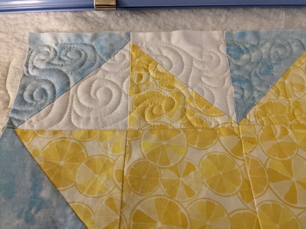 Part of my quilt top on the Cutie frame, quilted with swirls.