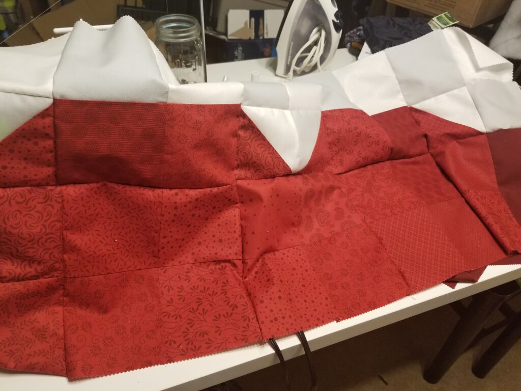 Top of one red heart for the original love is love quilt top pattern.