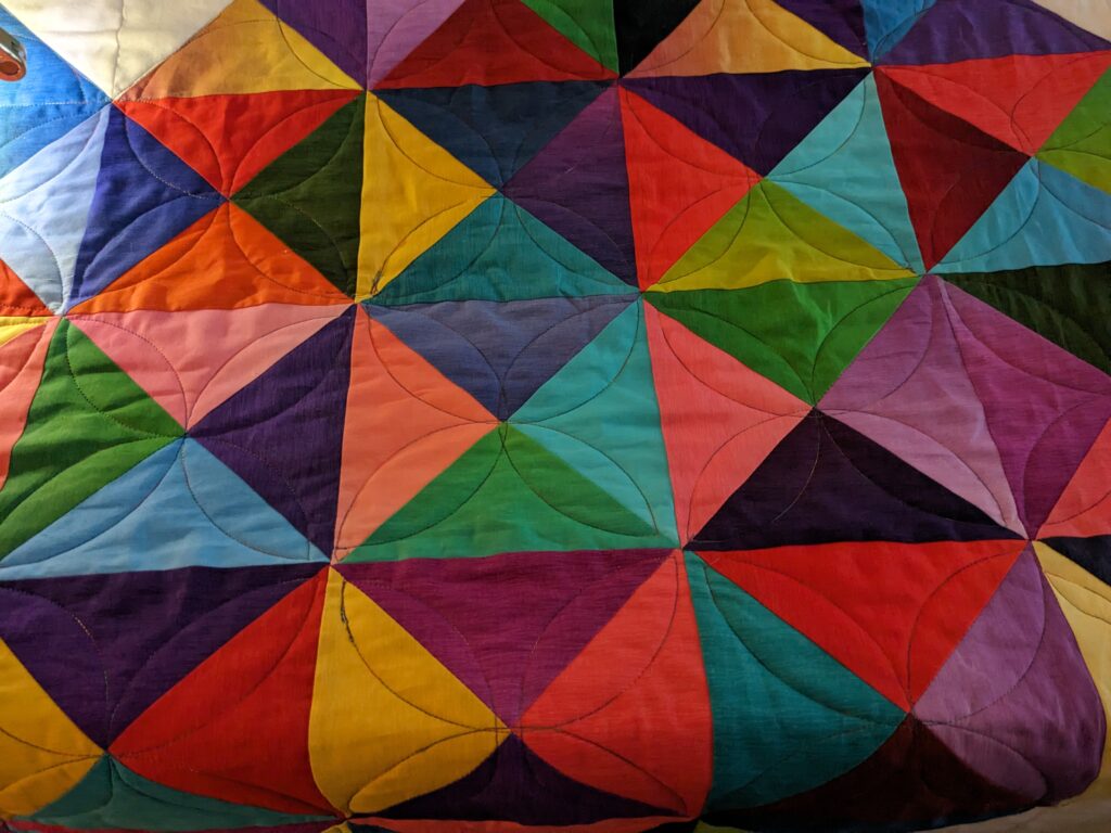 Curved ruler quilting in the 2nd heart.