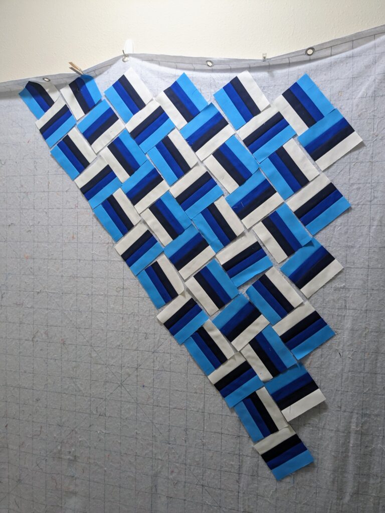 The wrong size rail fence squares laid out on the design wall.