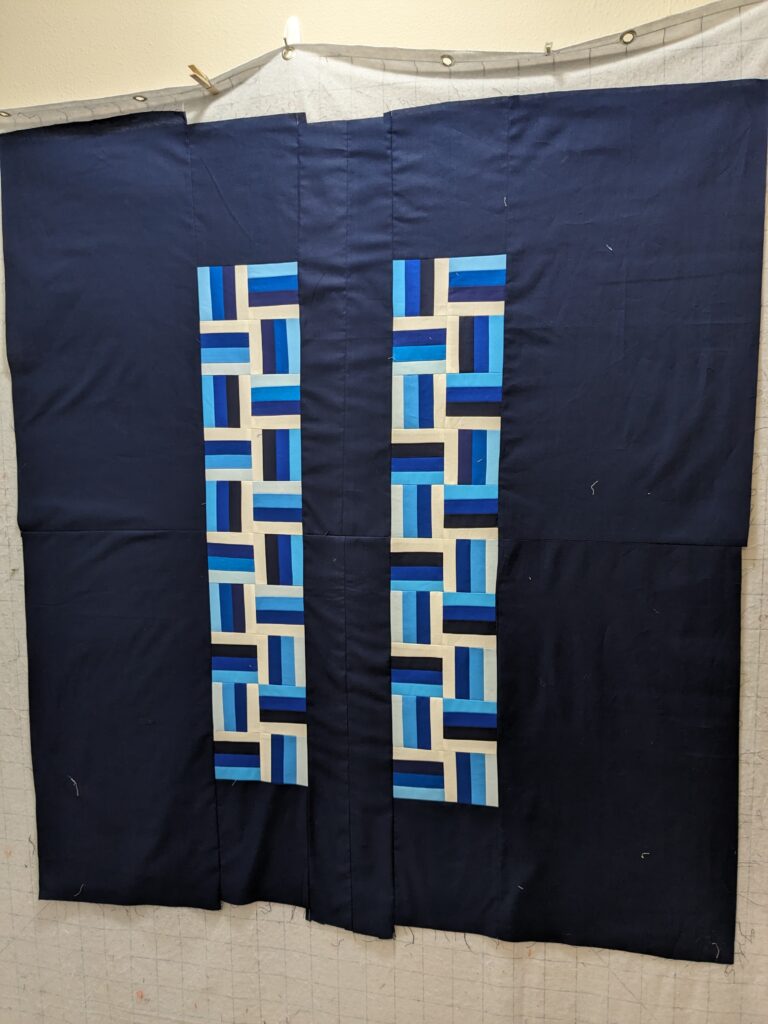 The pieced backing laid out on the design wall.