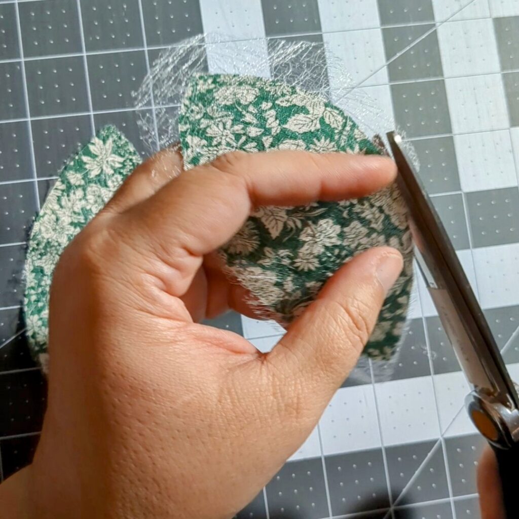 Me cutting Mistyfuse around the orange peel shaped fabric.