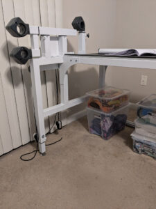A picture of the left side of the frame with the pieces attached that hold the rails.
